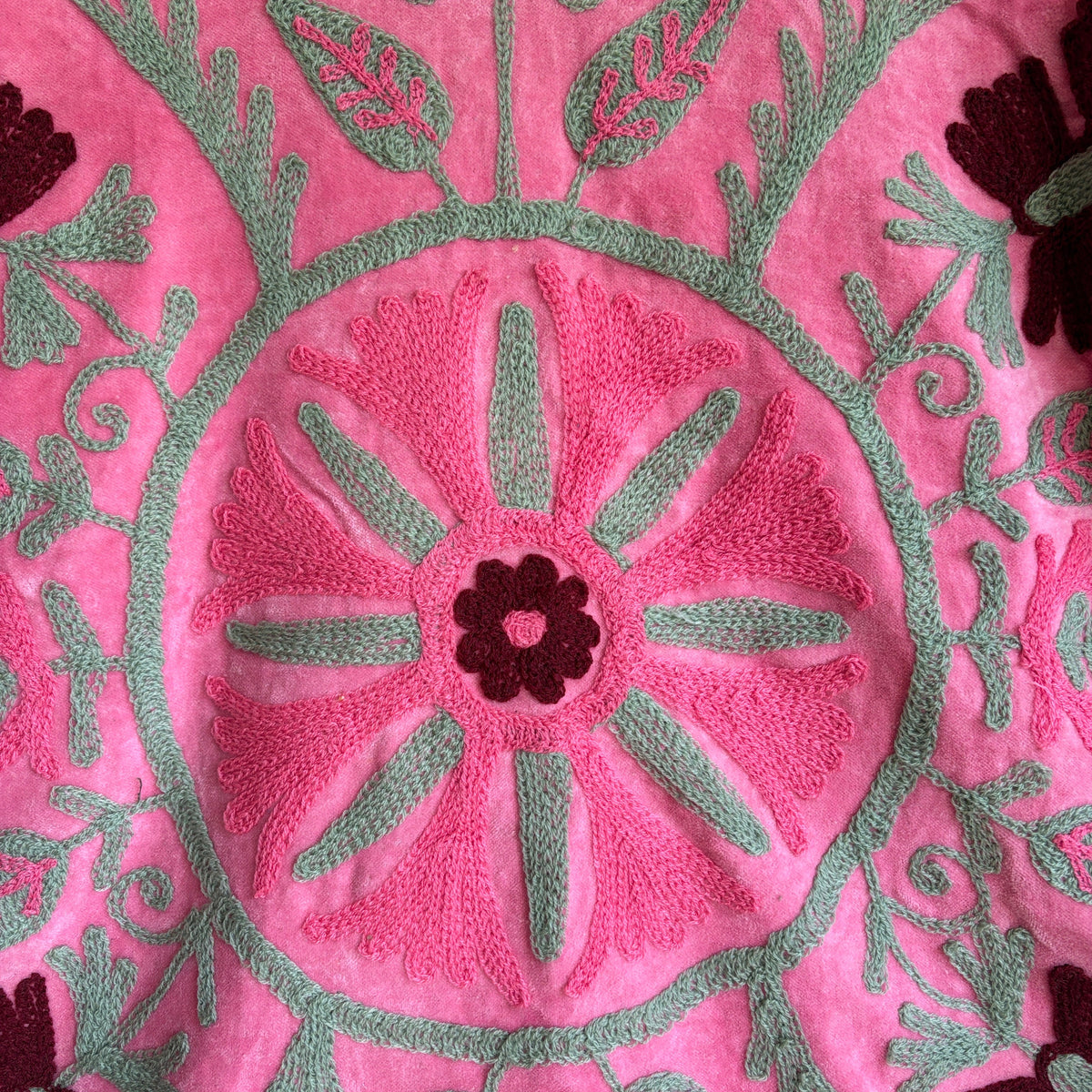 Pink Suzani embroidered Velvet jacket with green and dark red floral patterns. 