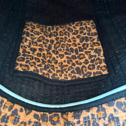 Leopard print tote bag with black trim and handles. 