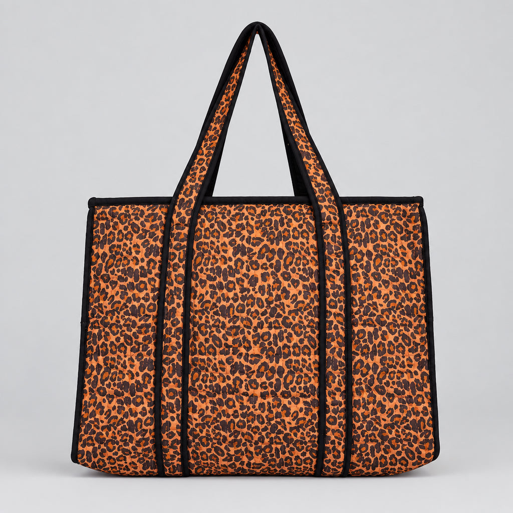 Leopard print tote bag with black trim and handles. 