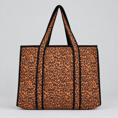 Leopard print tote bag with black trim and handles. 
