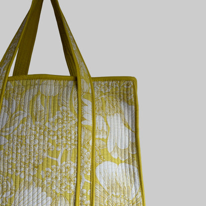 Cotton Quilted tote bag with a yellow and white floral pattern. 
