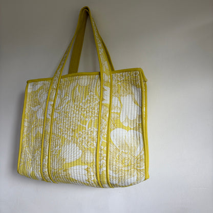 Cotton Quilted tote bag with a yellow and white floral pattern. 
