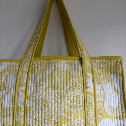 Cotton Quilted tote bag with a yellow and white floral pattern. 