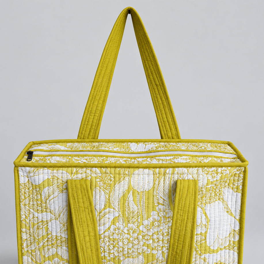 Cotton Quilted tote bag with a yellow and white floral pattern. 
