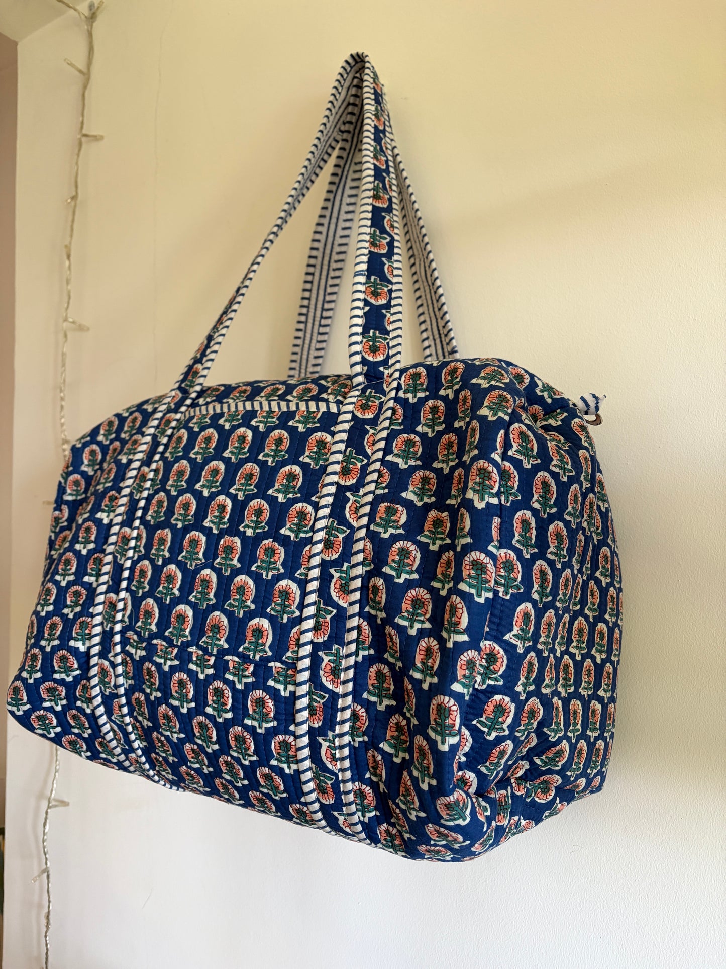 Blue quilted duffle bag UK side view spacious weekend bag