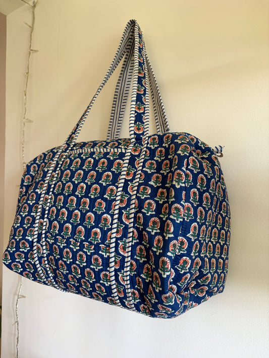 Blue quilted duffle bag UK side view spacious weekend bag