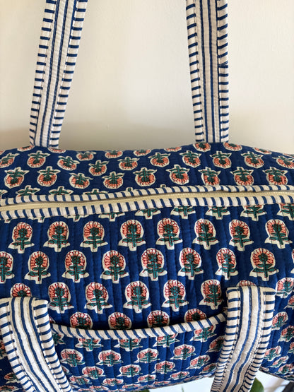 Blue quilted duffle bag UK close up fabric pattern detail
