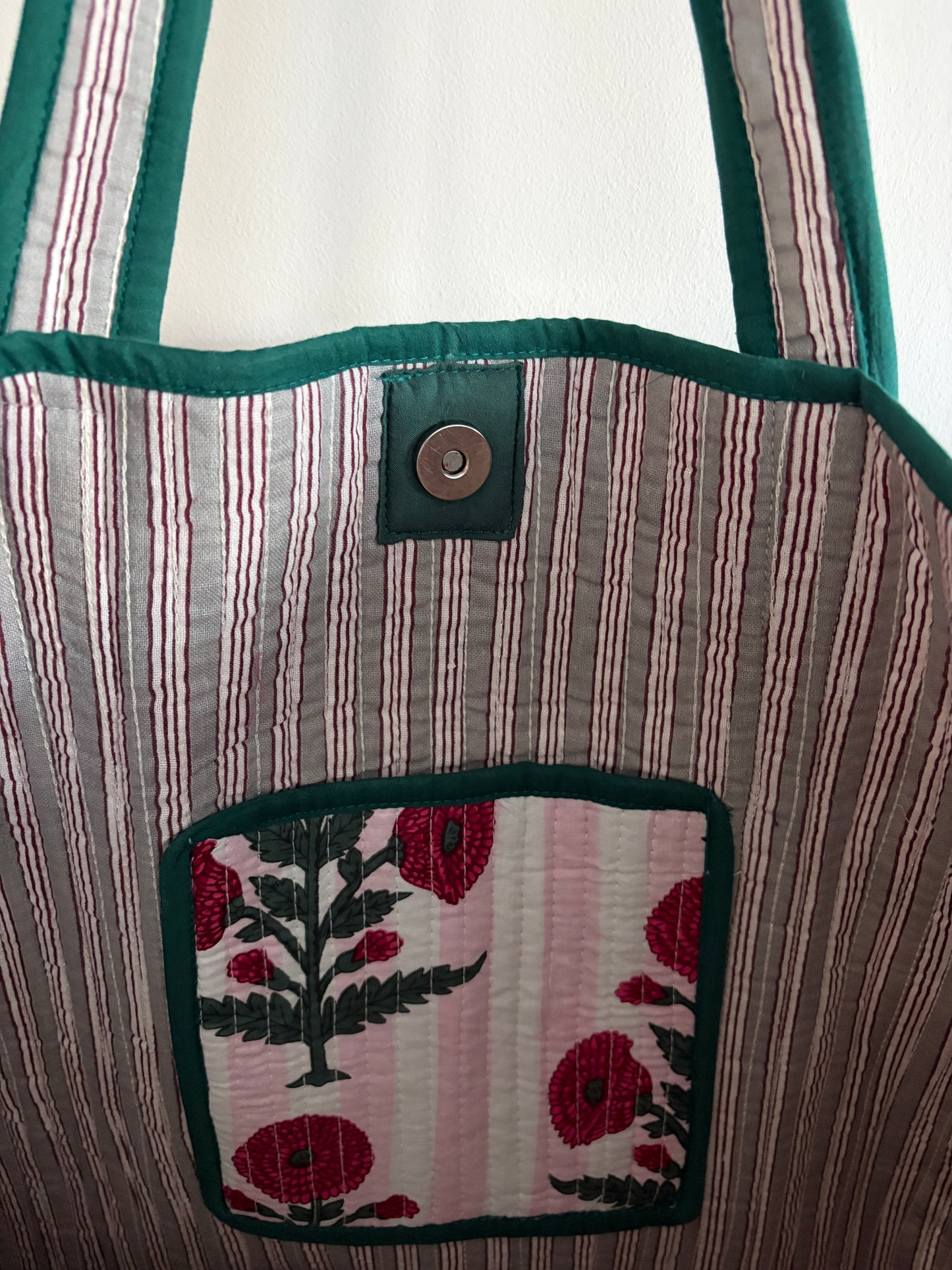 Quilted bag with floral embroidery on a mannequin inside view