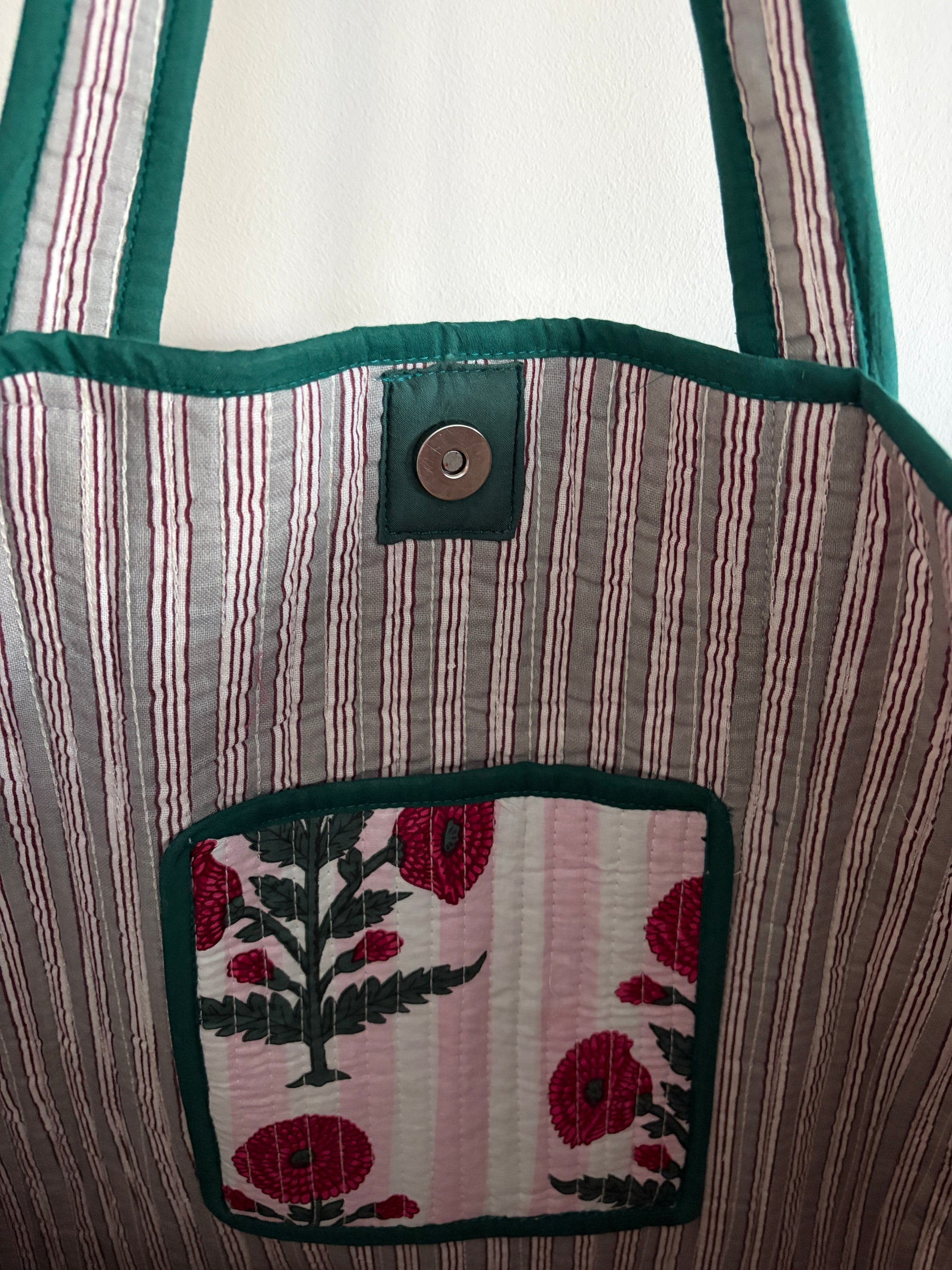 Quilted bag with floral embroidery on a mannequin inside view