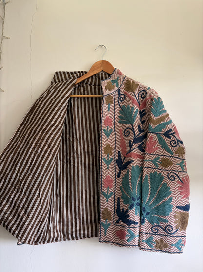 Floral-patterned headscarf and striped fabric on a white background