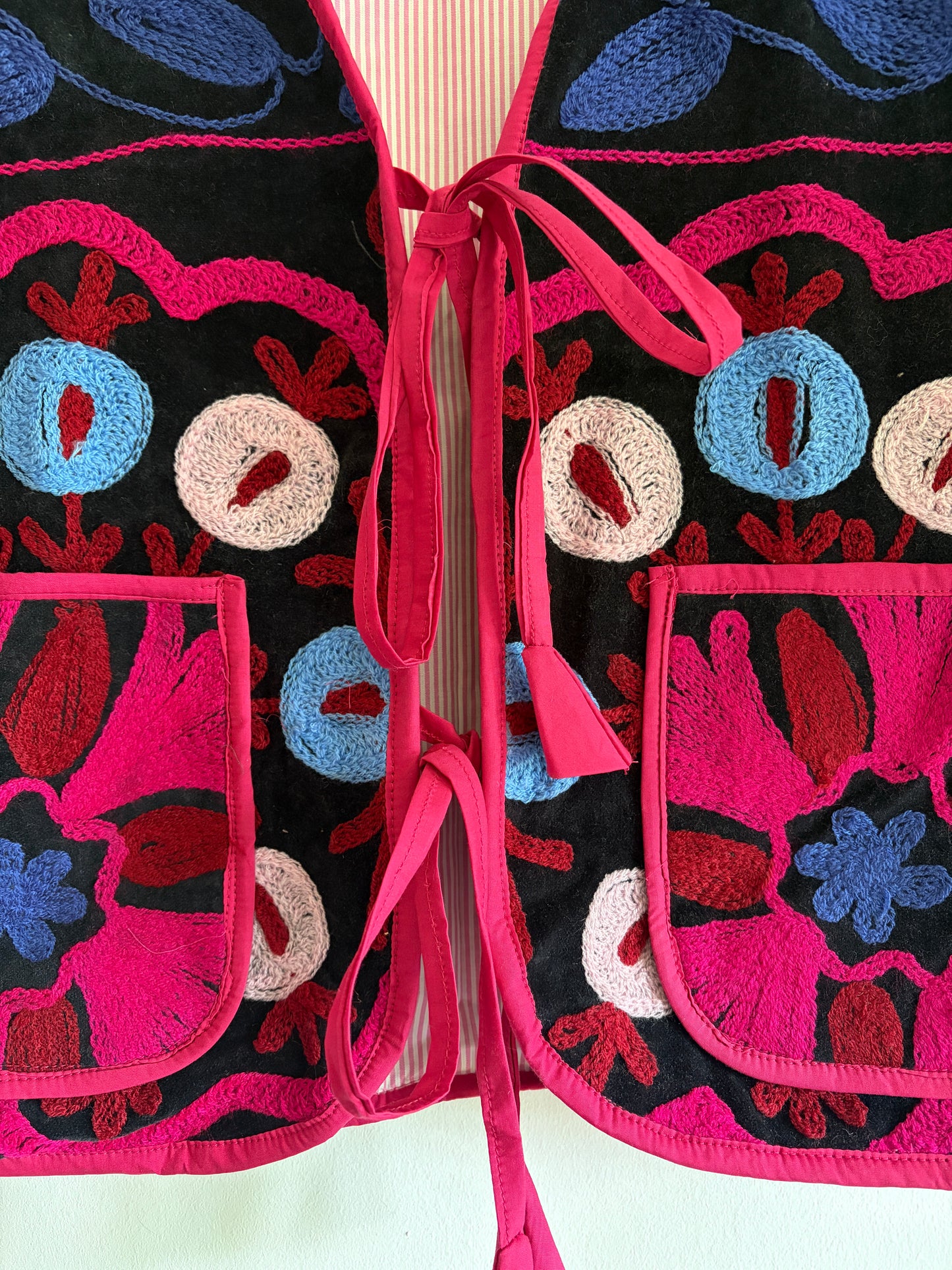 Fuchsia suzani embroidery vest UK close up floral embroidery velvet detail
