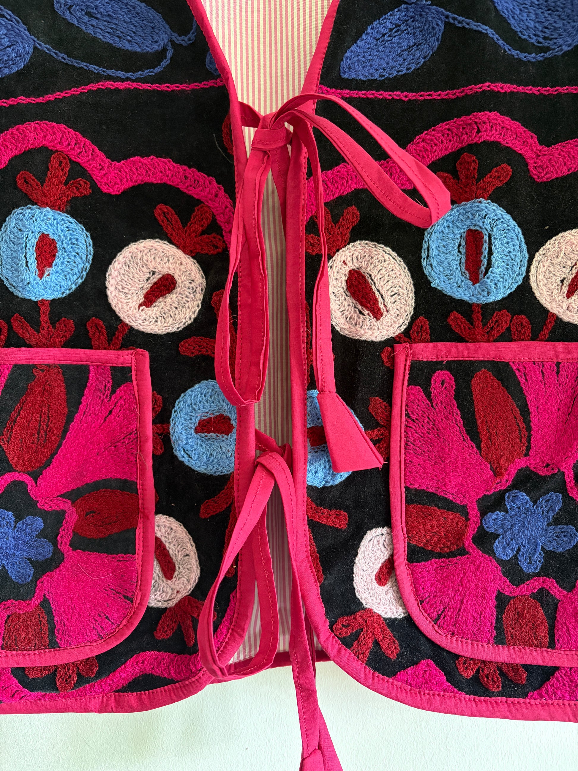 Fuchsia suzani embroidery vest UK close up floral embroidery velvet detail