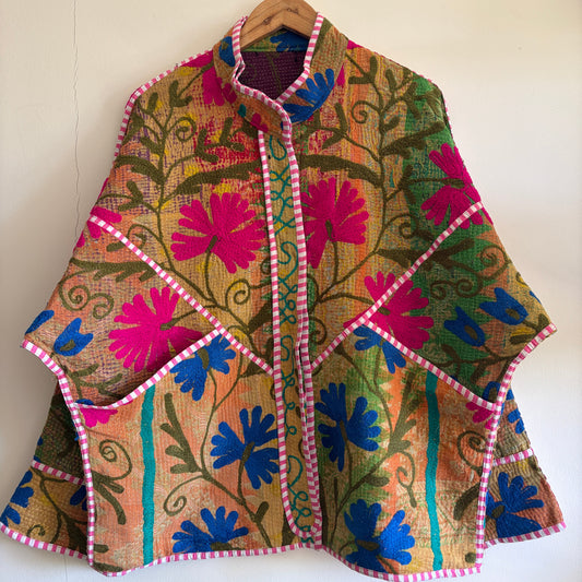 Colorful embroidered Suzani Jacket with floral patterns on a white background