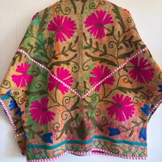 Colorful embroidered Suzani Jacket with floral patterns on a white background