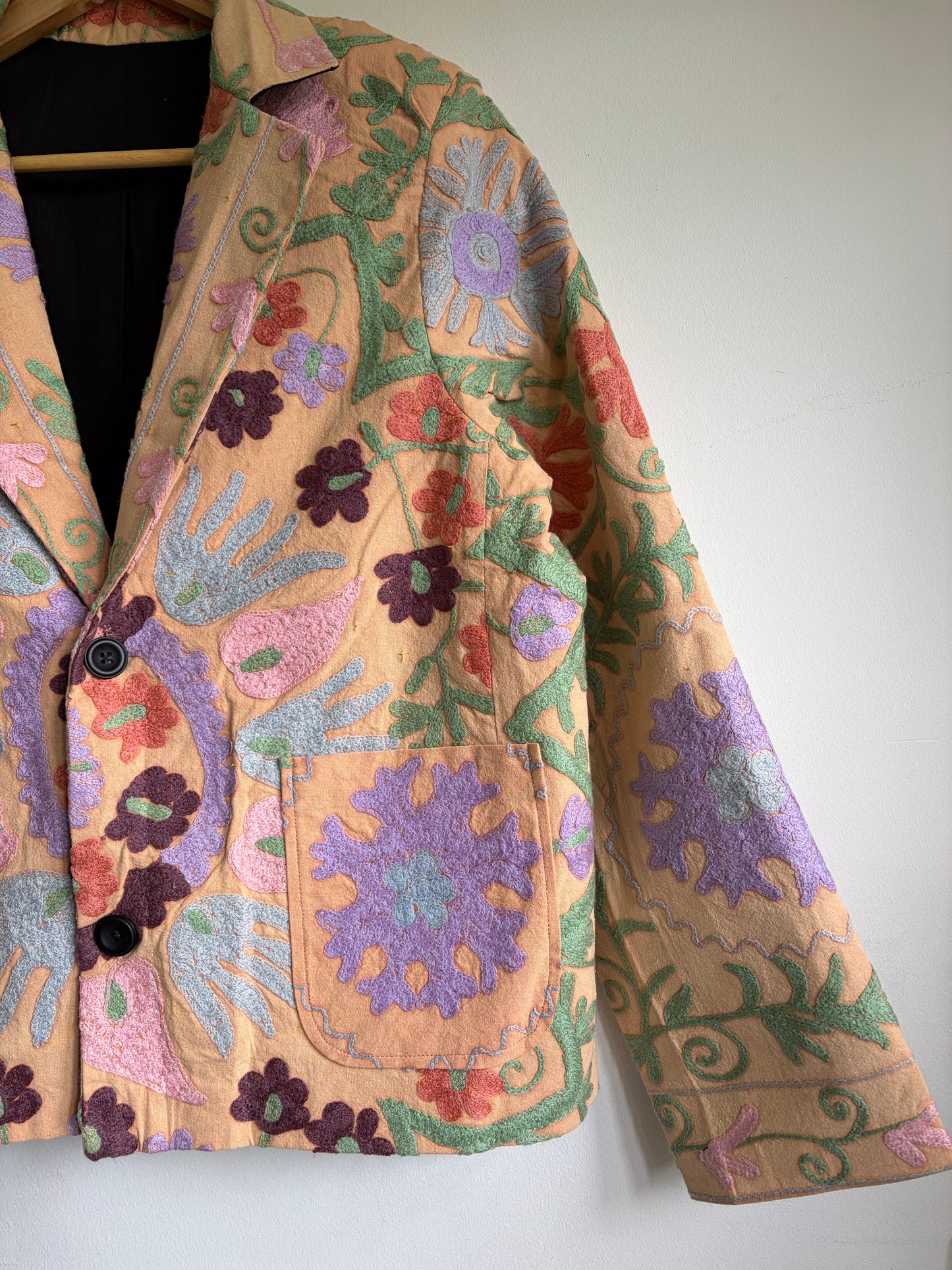 Suzani Floral Blazer on a hanger against a white background