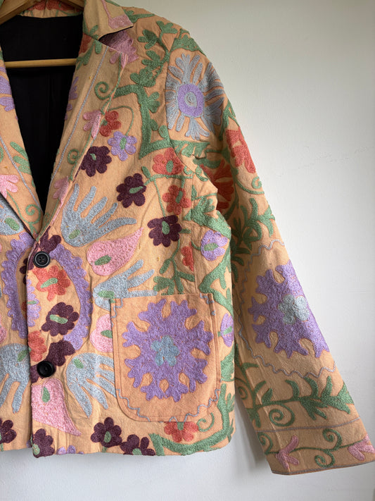 Suzani Floral Blazer on a hanger against a white background