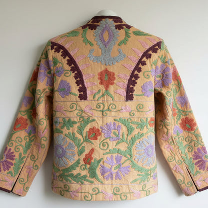 Suzani Floral Blazer with colorful floral patterns on a beige background