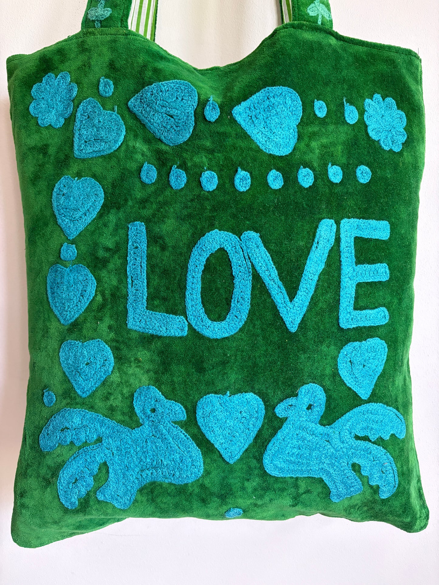 Green Suzani Velvet bag with blue hearts and 'LOVE' on a beige background
