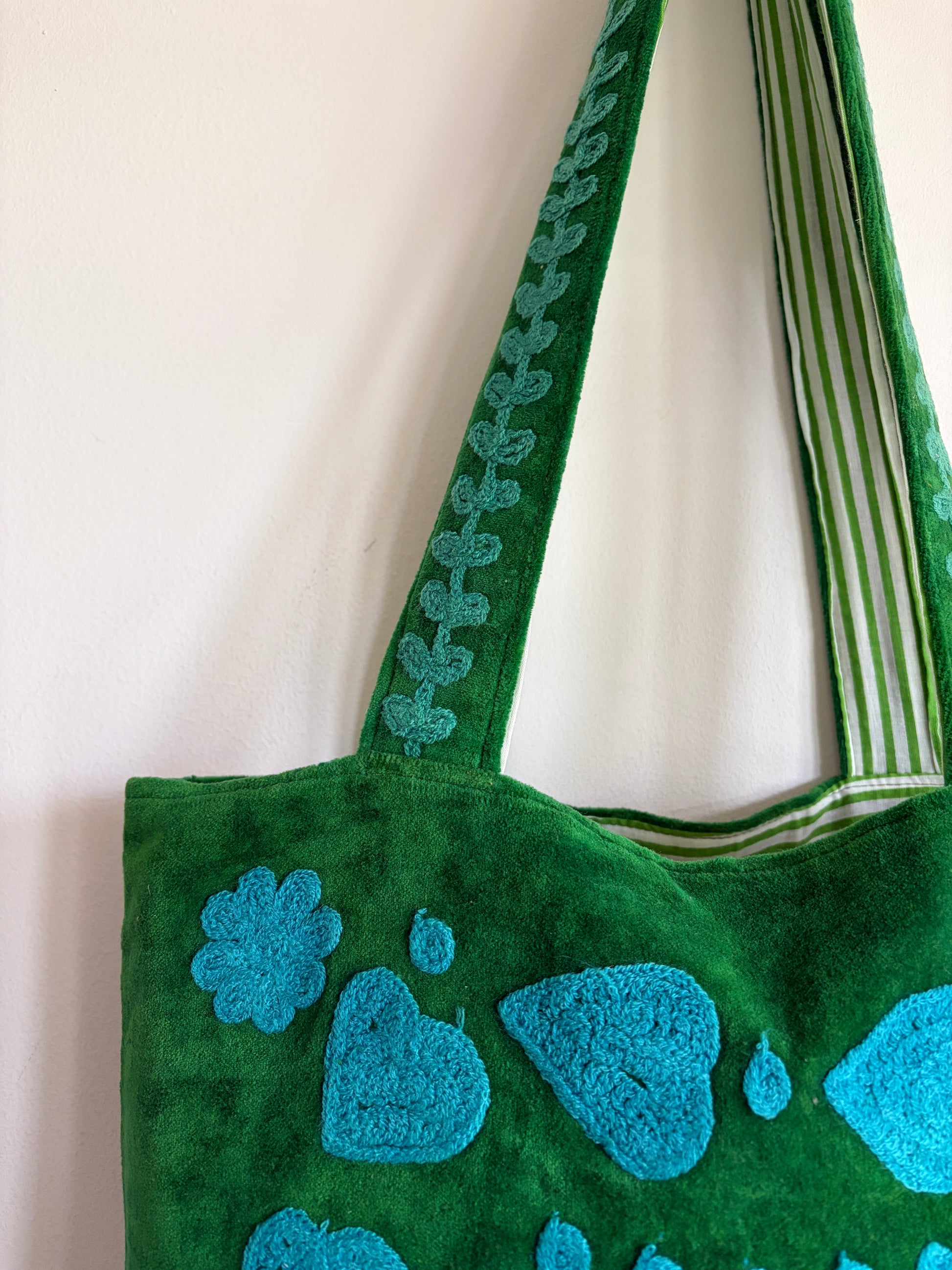 Green Suzani Velvet bag with blue hearts and 'LOVE' on a beige background