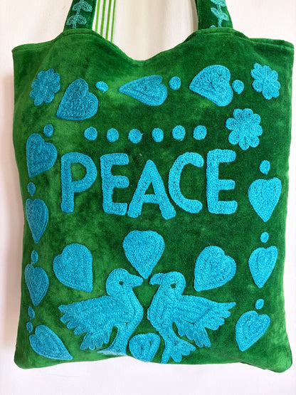 Green Suzani Velvet bag with blue hearts and 'LOVE' on a beige background