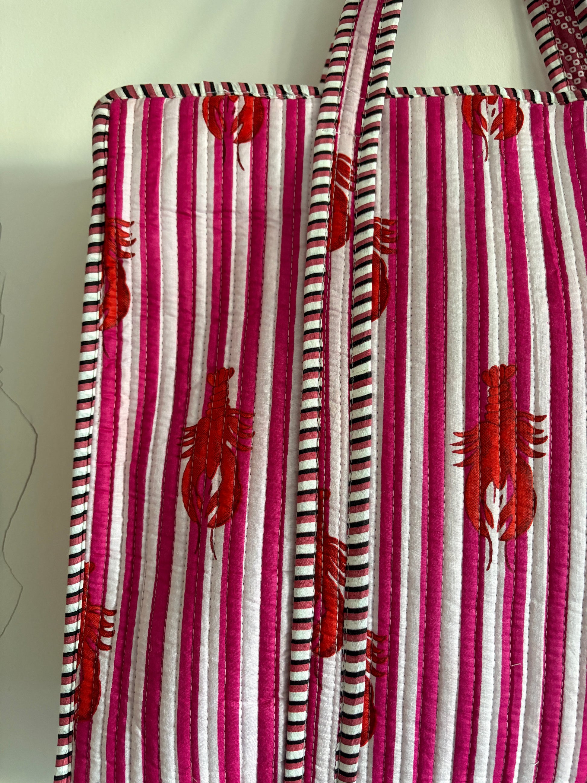 Striped fabric with red lobster patterns on a white background