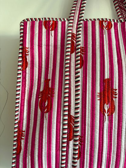 Striped fabric with red lobster patterns on a white background