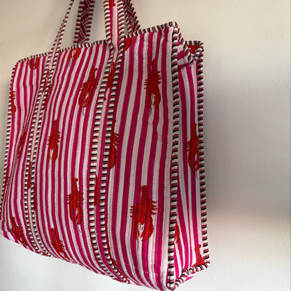 Red and white striped bag with lobster pattern on a light background