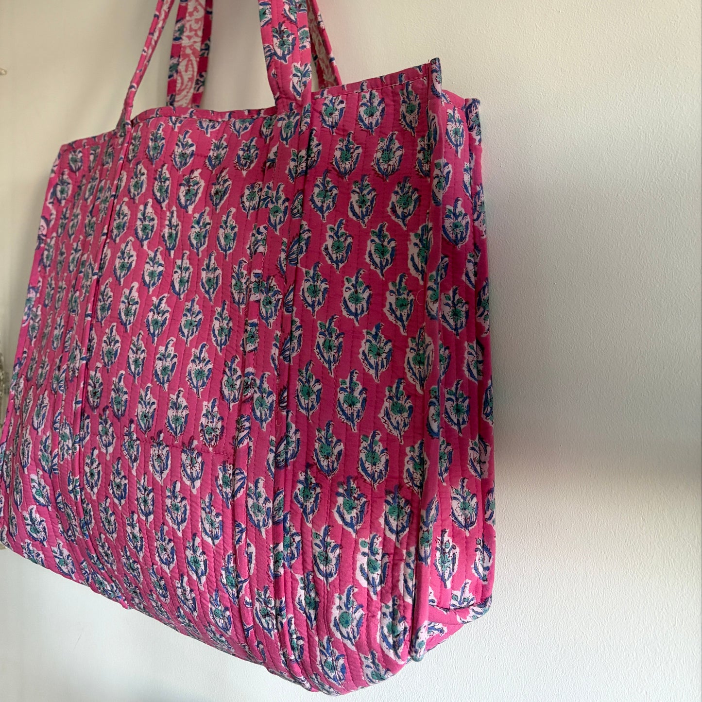 Pink floral-patterned bag on a white background
