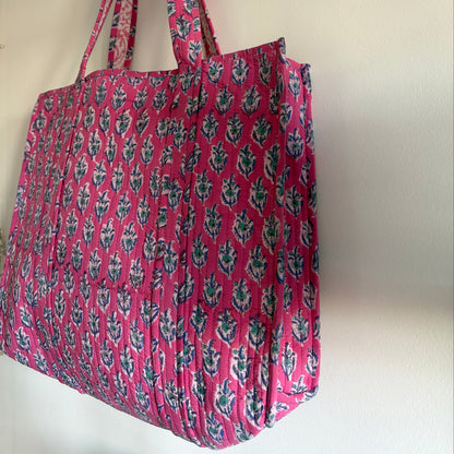 Pink floral-patterned bag on a white background