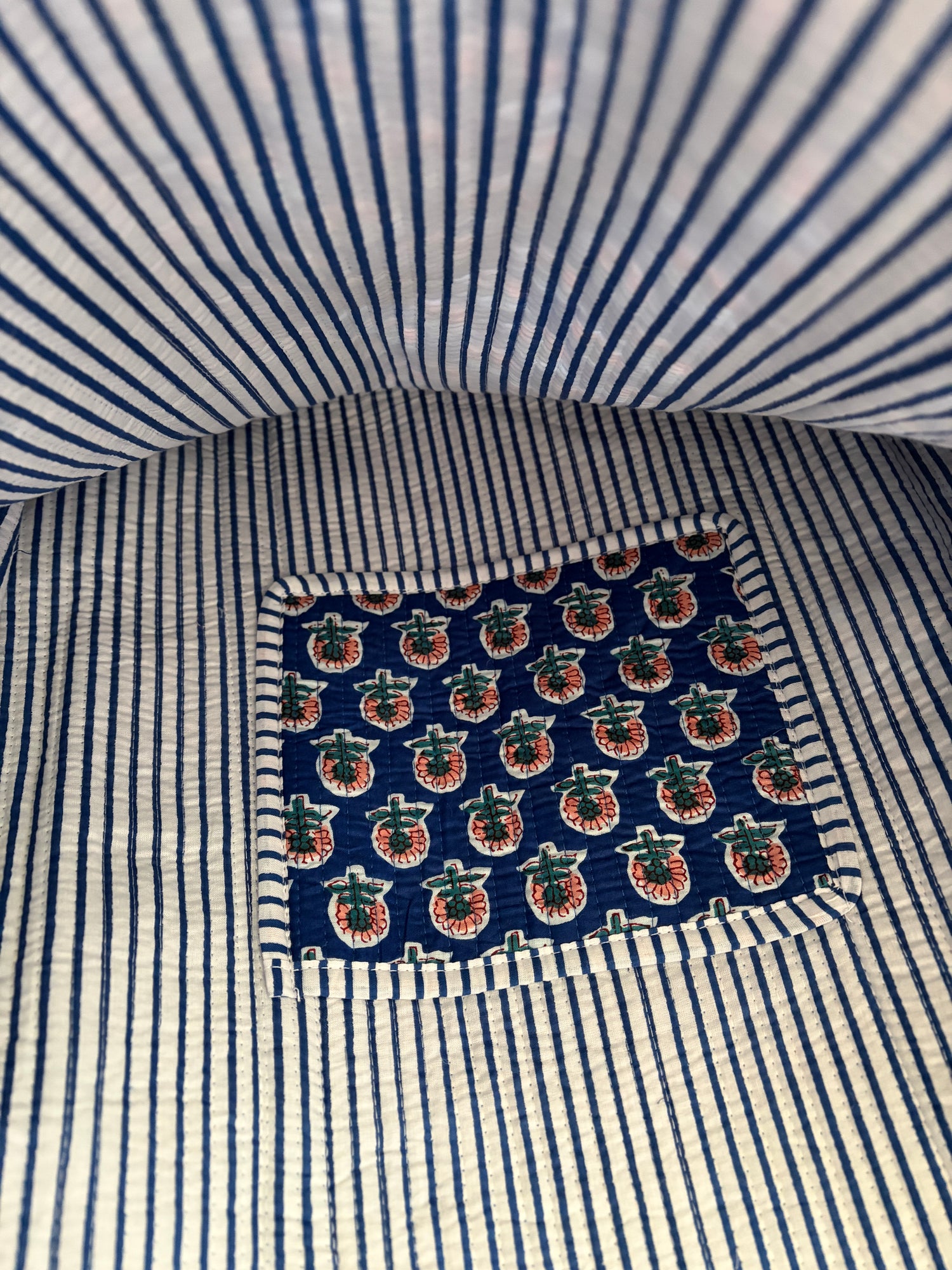 Close-up of a striped tote bag inside with a patterned pocket