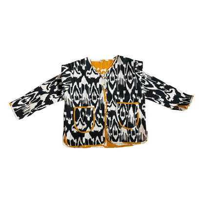 Black and white patterned jacket with orange accents on a white background