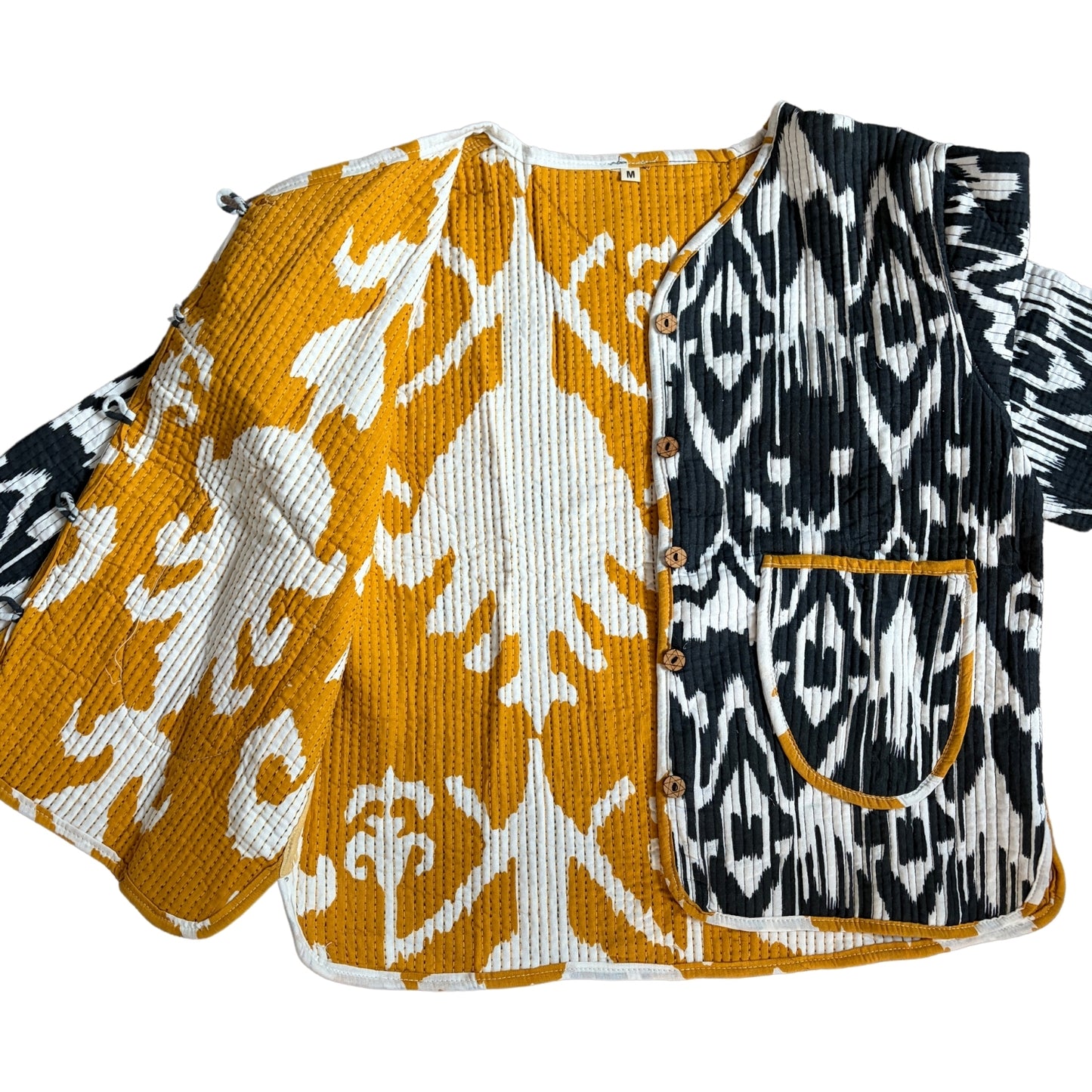 Two patterned tops with orange and white design on one and black and white design on the other, on a white background.