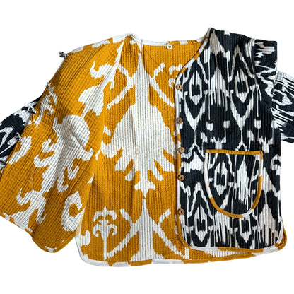 Two patterned tops with orange and white design on one and black and white design on the other, on a white background.