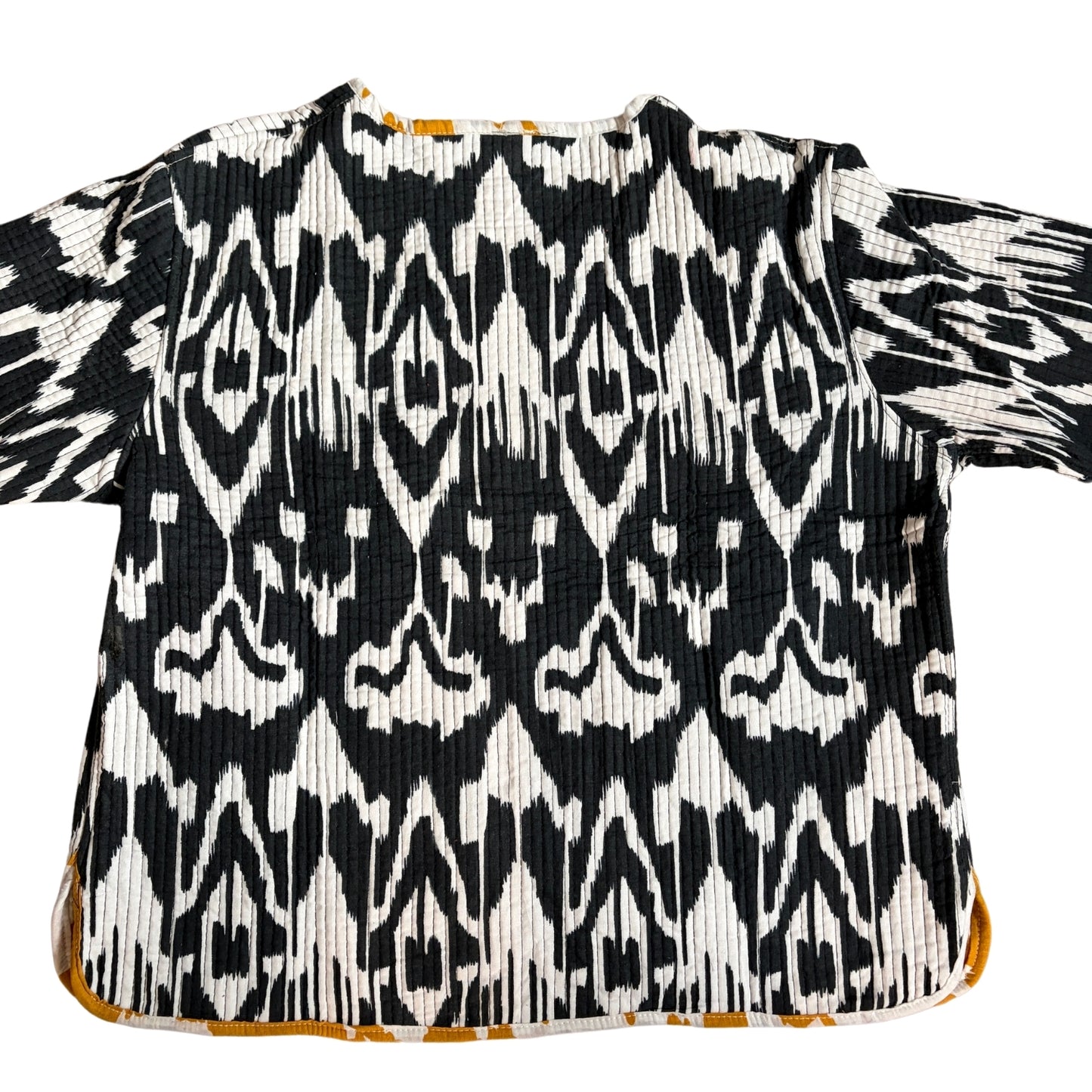 Black and white patterned top with short sleeves on a white background