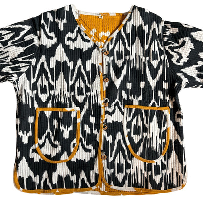 Black and white patterned jacket with orange accents on a white background