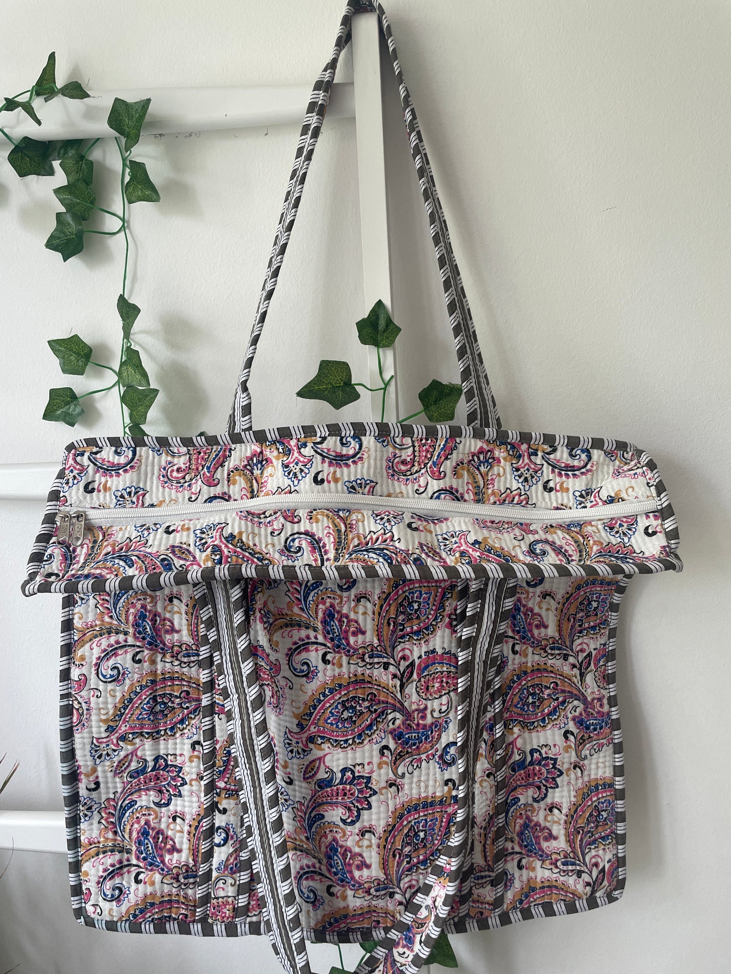 Patterned fabric bag with a strap on a white background