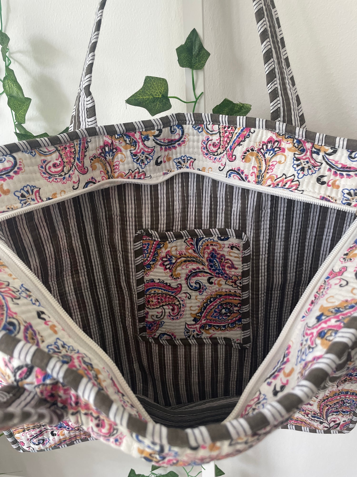 Decorative fabric with paisley patterns and stripes on a white background