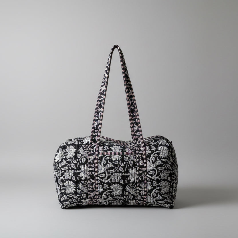 Black and white floral-patterned bag on a light-colored surface