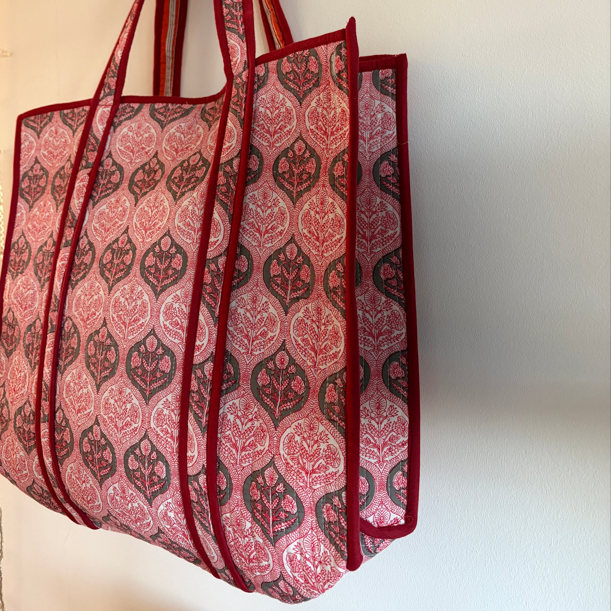 Red and pink patterned fabric on a white background