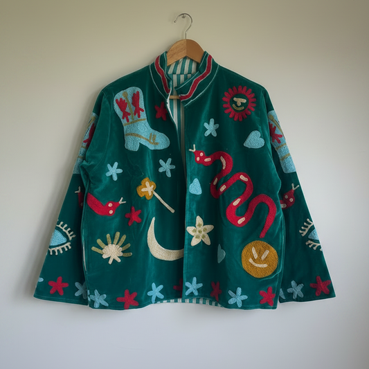 Colorful Suzani jacket on a plain wall.