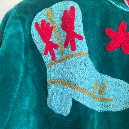 Colorful Suzani jacket on a plain wall
