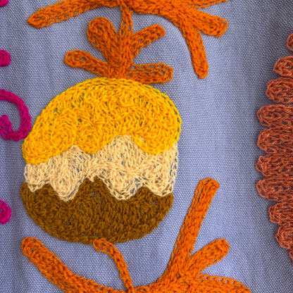 A purple hoodie with colorful suzani embroidery. 