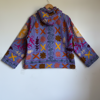 A purple hoodie with colorful suzani embroidery. 