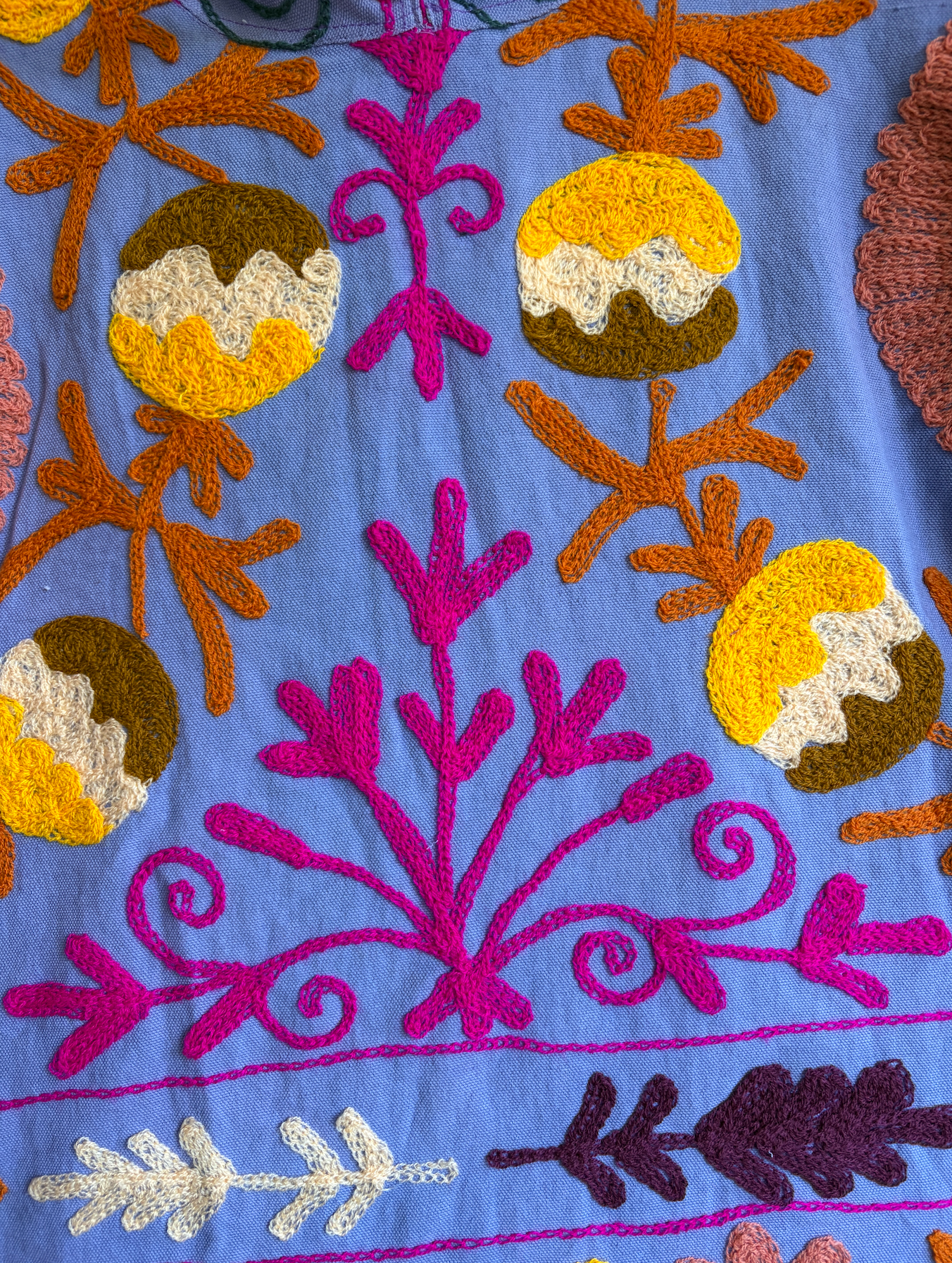 A purple hoodie with colorful suzani embroidery. 