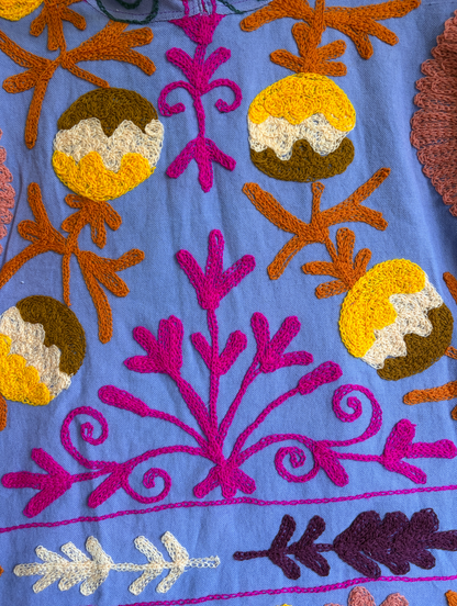 A purple hoodie with colorful suzani embroidery. 