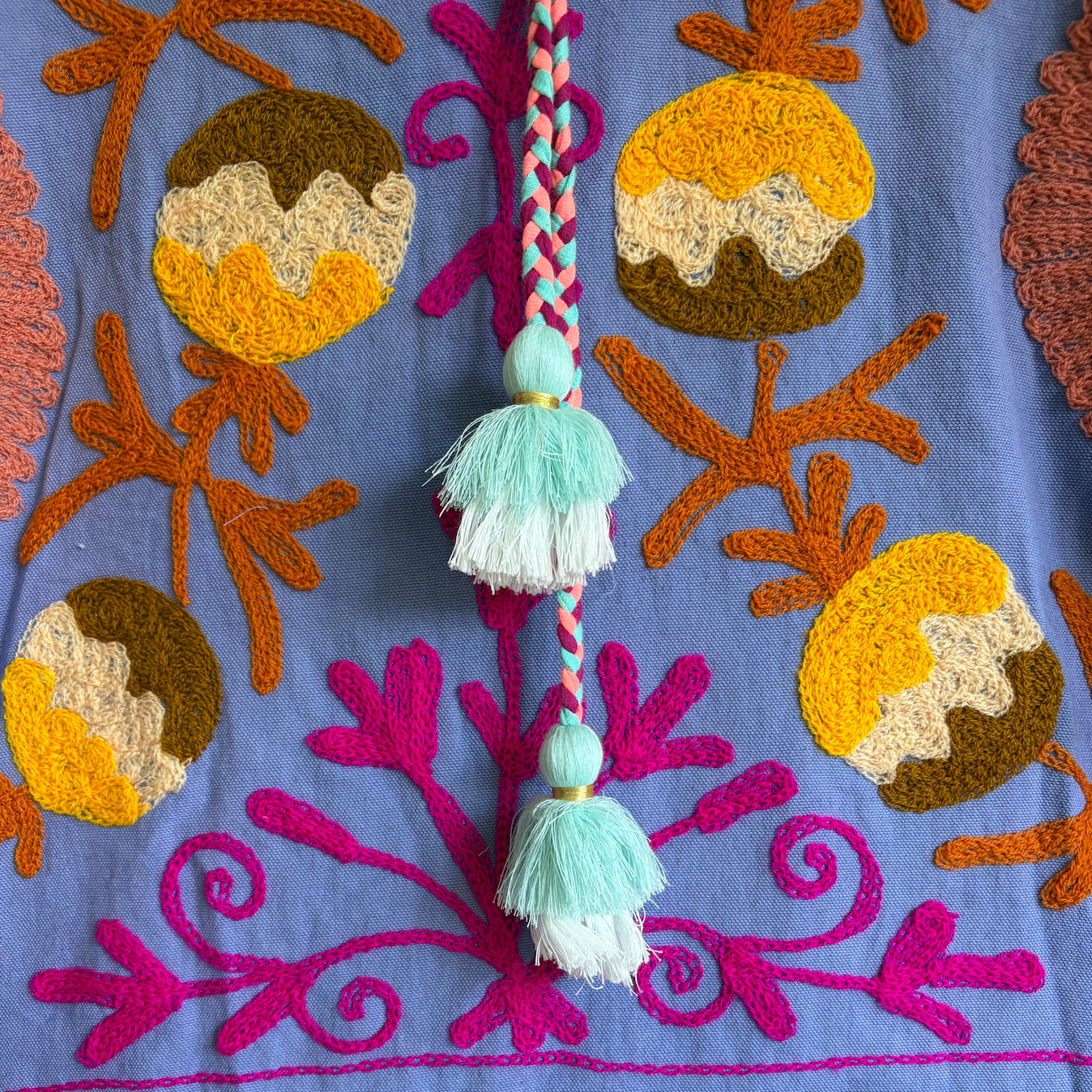 A purple hoodie with colorful suzani embroidery. 