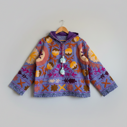 A purple hoodie with colorful suzani embroidery. 