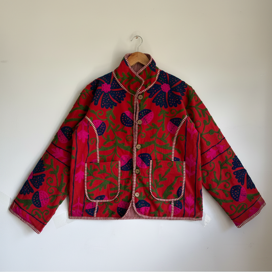 A red Suzani Embroidery jacket with a colorful floral and butterfly pattern. 