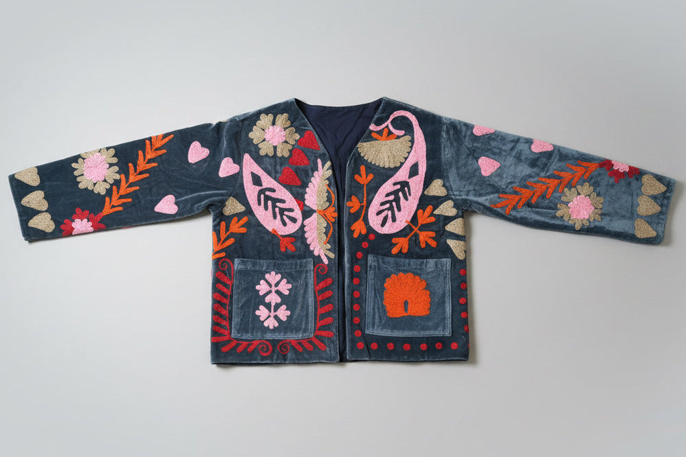 Embroidered Jacket  with colorful patterns on a beige surface