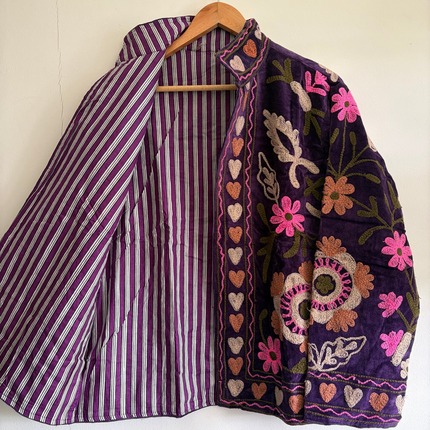 Purple embroidered Jacket with floral patterns on a white background
